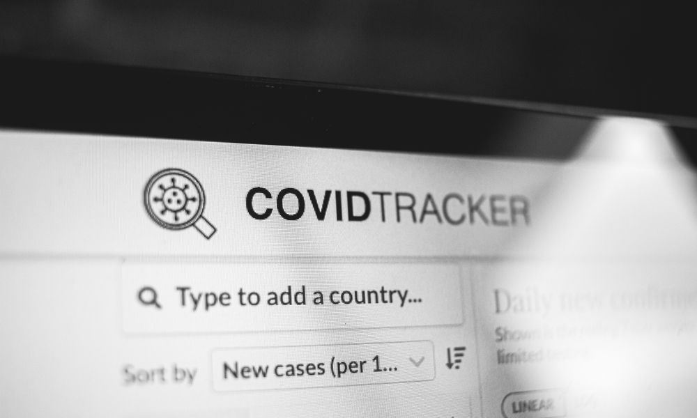 Black and white of inscription with virus in magnifier symbol above search engine with data about COVID 19 pandemic on netboo