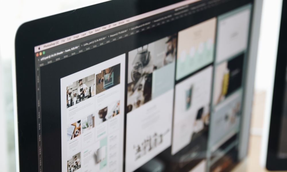 A modern computer screen displaying web design work, showcasing creative visuals in a workspace.