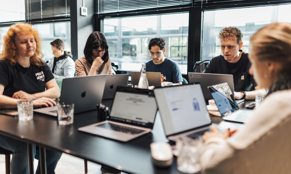 Focused team engaged in discussion and planning at a modern office setting.