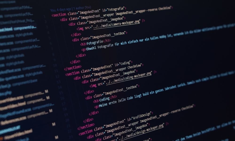 Close-up view of HTML code displayed on a dark screen, showcasing coding concepts.