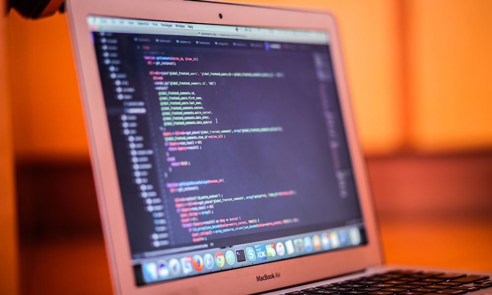 Focused shot of a laptop displaying code, suitable for tech and coding themes.