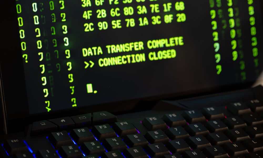 Data transfer complete message displayed on a computer monitor with a keyboard underneath.
