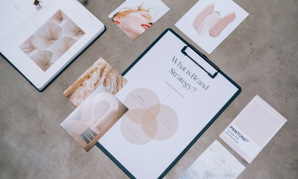 Flat lay showing branding materials and design concepts for creative strategy discussions.
