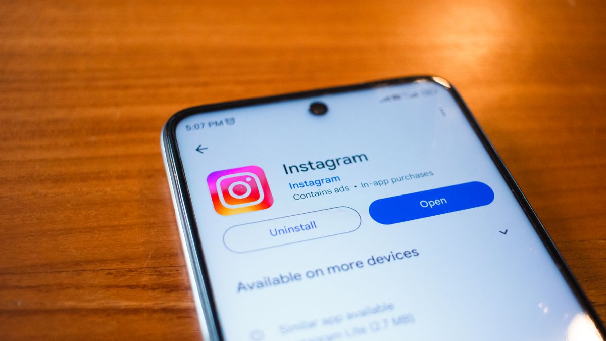A smartphone displaying the Instagram app open option on a wooden table.