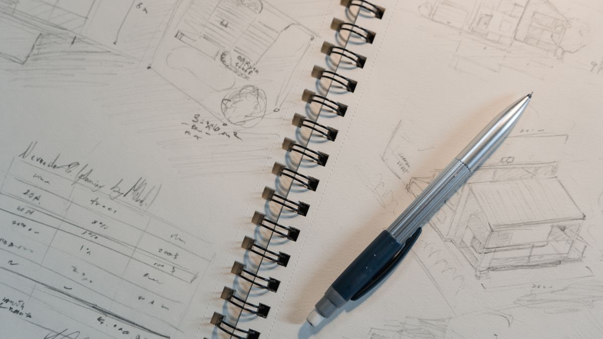 Explore detailed architectural sketches and designs on a spiral notepad with a mechanical pencil.