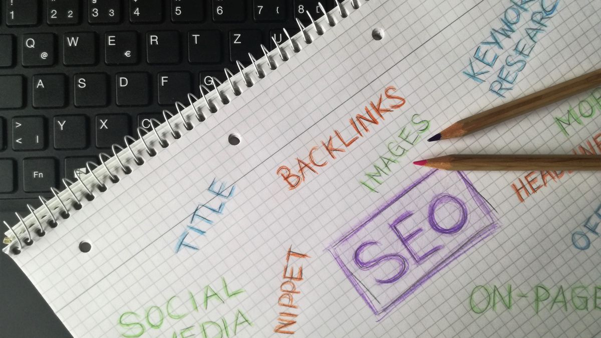 Close-up of notebook with SEO terms and keywords, highlighting digital marketing strategy.