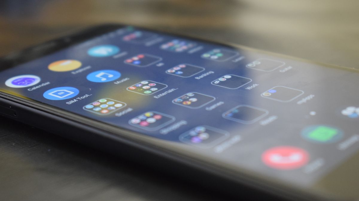 Close-up shot of a smartphone screen showing various app icons, indicating digital technology use.