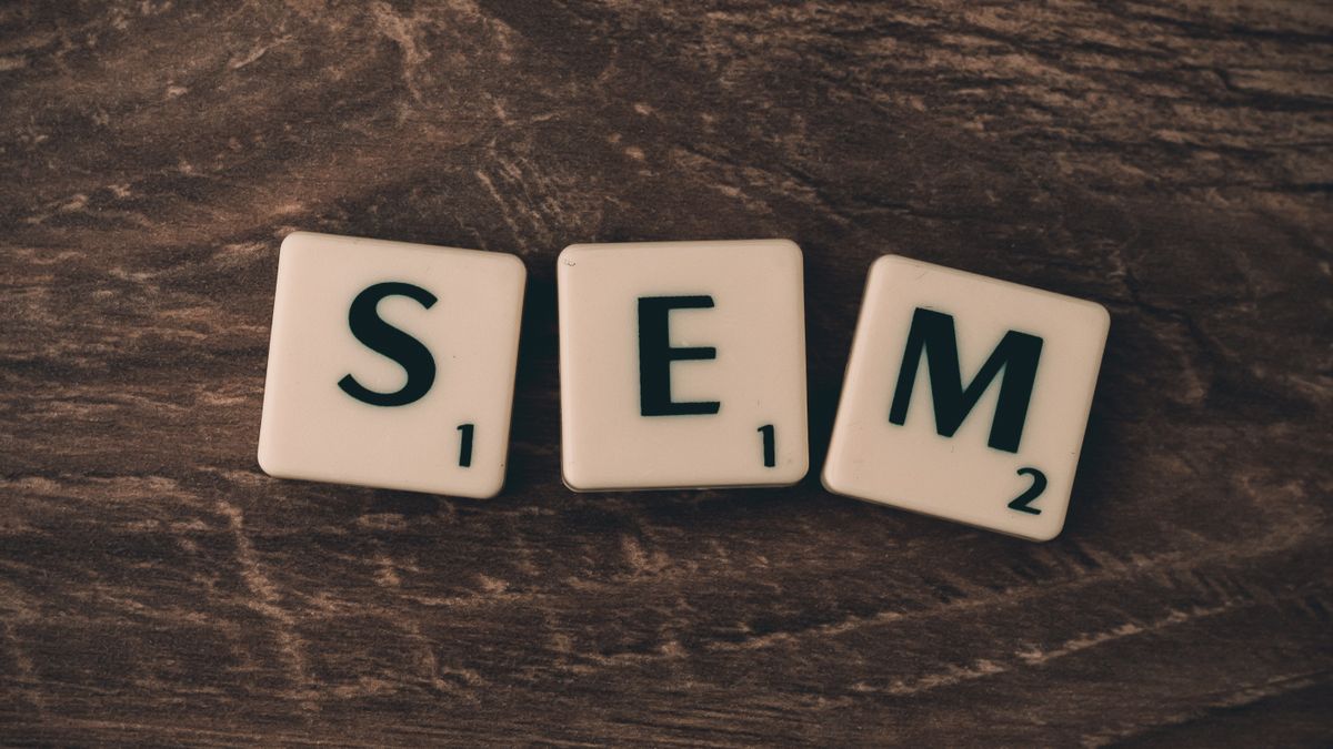 Wooden background with letter tiles spelling SEM, representing search engine marketing.