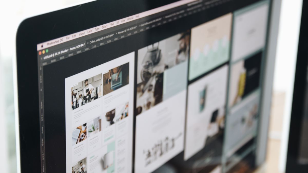 A modern computer screen displaying web design work, showcasing creative visuals in a workspace.