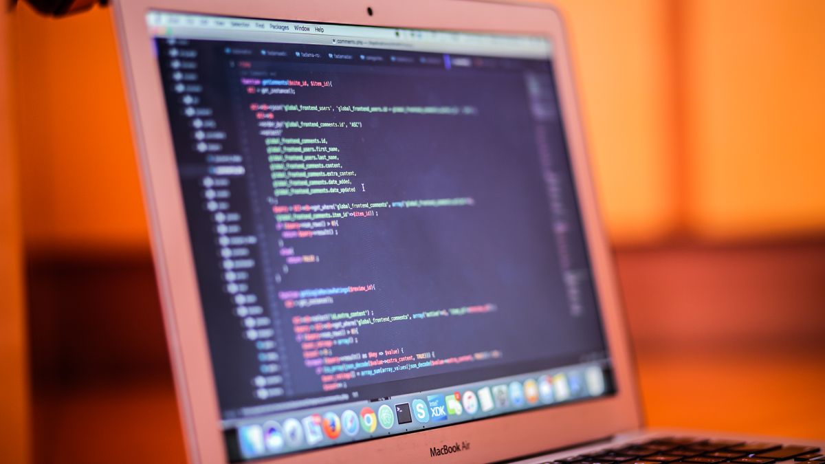 Focused shot of a laptop displaying code, suitable for tech and coding themes.