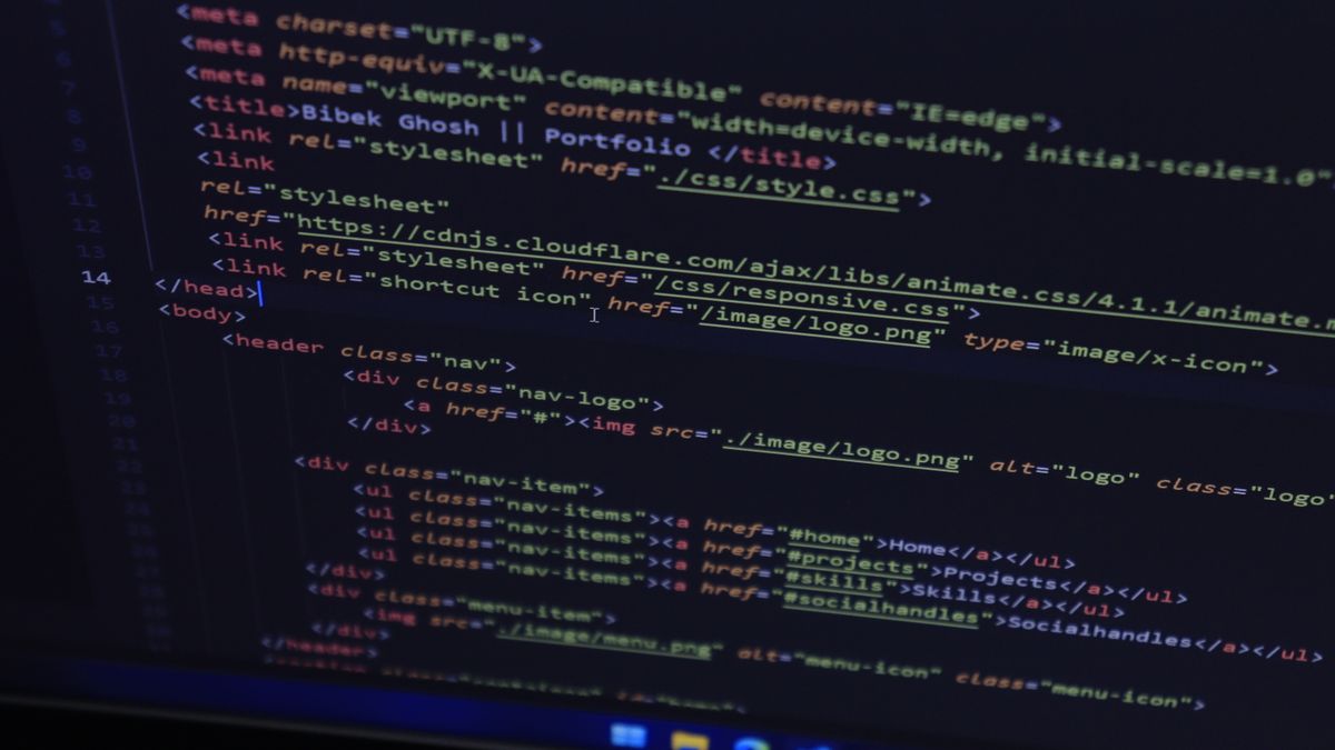 High-resolution close-up of HTML code displayed on a computer screen, perfect for technology themes.
