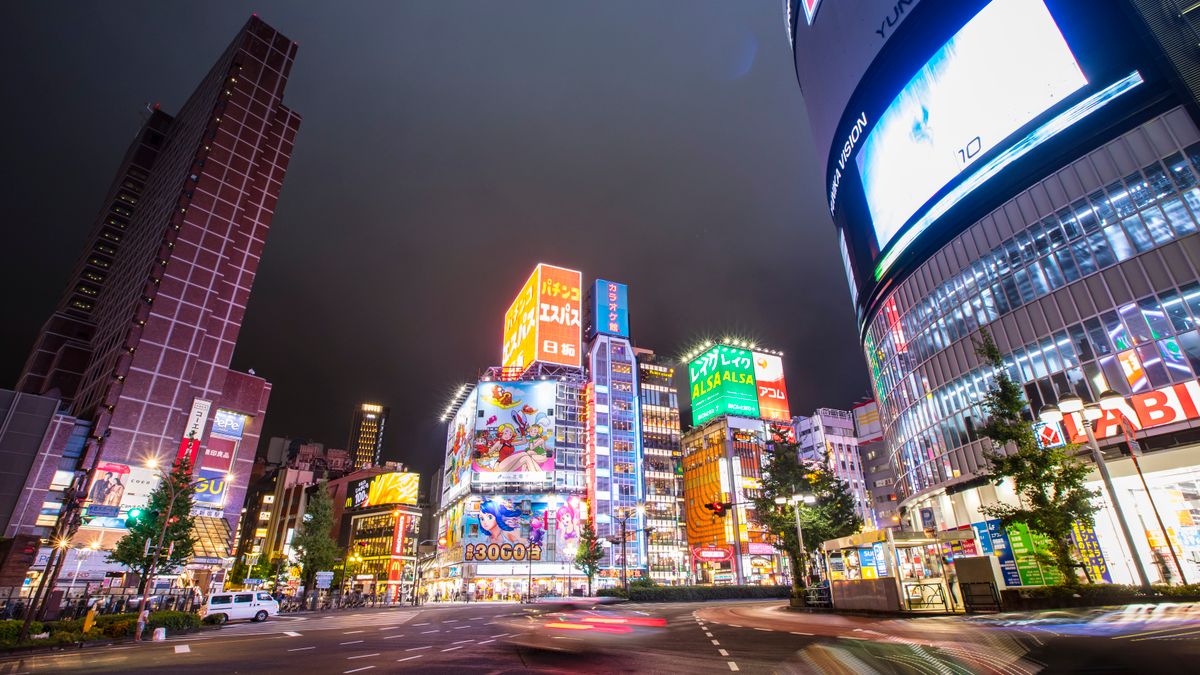 Bright and lively Shinjuku cityscape at night with neon lights and bustling streets.